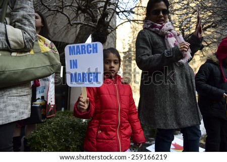 NEW YORK CITY - MARCH 8 2015: United Nations International Women\'s Day was marked with a rally in Dag Hammarskjold Plaza & march to Times Square. Young woman with March in March sign