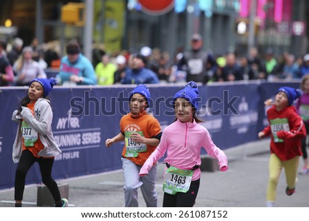 NEW YORK CITY - MARCH 15 2015: the New York Road Runners held their first ever Times Square Kids' Run a 1500 meter run coinciding with the NYRR annual Half Marathon on Seventh Avenue