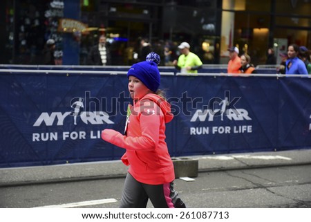 NEW YORK CITY - MARCH 15 2015: the New York Road Runners held their first ever Times Square Kids\' Run a 1500 meter run coinciding with the NYRR annual Half Marathon on Seventh Avenue