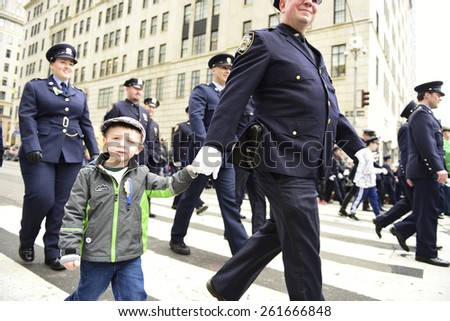 NEW YORK CITY - MARCH 17 2015: the 254th St. Patrick's Day parade, led by grand marshal Timothy Cardinal Dolan, filled Fifth Avenue in Midtown in spite of protests from the Irish Queers organization