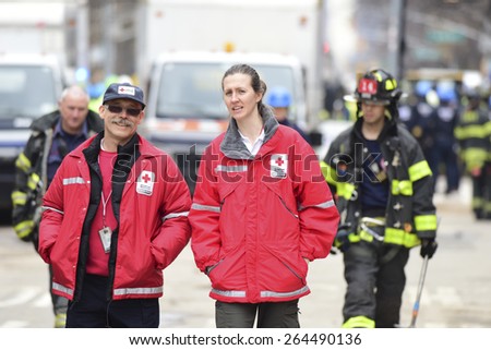 NEW YORK CITY - MARCH 27 2015: one day after a fire & explosion in Manhattan\'s East Village,2 people remain missing while workers clear the wreckage of three destroyed brownstones. Red Cross personnel