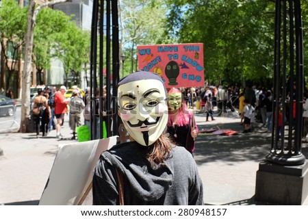 NEW YORK CITY - MAY 23 2015: environmental activists joined a worldwide Stop Monsanto movement in New York with a march from Dag Hammarskjold Plaza to Tompkins Square. Activists in Guy Fawkes masks
