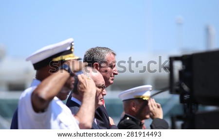 NEW YORK CITY - 25 MAY 2015: Mayor Bill de Blasio & Gen John Kelly presided over Memorial Day observances on Pier 86 by the USS Intrepid. Saluting for Star Spangled Banner on pier 86