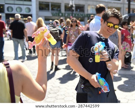NEW YORK CITY - JUNE 13 2015: happn, sponsors of the Washington Square pillow fight, staged a bubble battle inspired by a Dr Seuss classic at Union Square Park attended by hundreds.