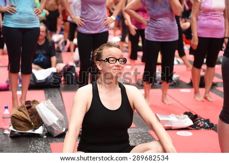 NEW YORK CITY - JUNE 22 2015: the summer solstice was celebrated in Times Square with the first International Day of Yoga, a joint effort by the United Nations & Times Square Alliance drawing hundreds