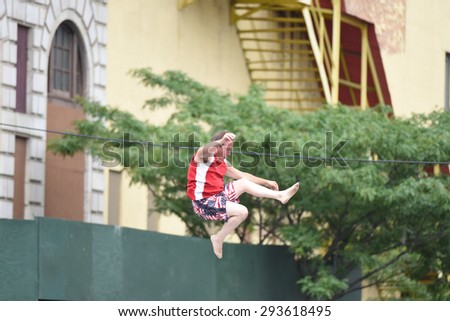 NEW YORK CITY - JULY 4 2015: Nathan\'s Famous staged its annual fourth of July hot dog eating contest in Coney Island, Brooklyn. Trampoline demonstration on Stillwell Avenue