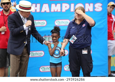 NEW YORK CITY - JULY 4 2015: Nathan\'s Famous staged their annual fourth of July hot dog eating contest in Coney Island, Brooklyn. Little girl temporarily separated from her parents