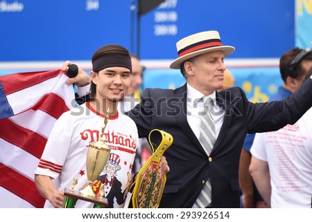 NEW YORK CITY - JULY 4 2015: Nathan\'s Famous staged their annual fourth of July hot dog eating contest in Coney Island, Brooklyn. Contest winner Matt Stonie with promoter & MC George Shea