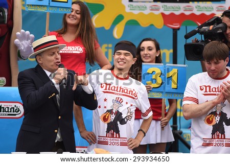 NEW YORK CITY - JULY 4 2015: Nathan\'s Famous held its annual fourth of July hot dog eating contest in Coney Island, Brooklyn. Promoter & MC congratulates winner Matt Stonie