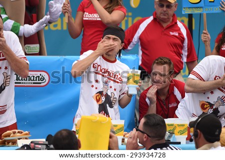 NEW YORK CITY - JULY 4 2015: Nathan\'s Famous held its annual fourth of July hot dog eating contest in Coney Island, Brooklyn. Matt Stonie nears the end of the competition