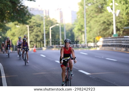 NEW YORK CITY - JULY 19 2015: thousands endured heat & humidity to complete the final 10 kilometer leg of the NYC Panasonic Triathlon in Central Park. Bike portion of Triathlon on Henry Hudson Prkwy