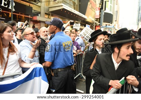 NEW YORK CITY - JULY 22 2015: thousands rallied in Times Square to oppose the President\'s proposed nuclear deal with Iran. NYPD community affairs personnel keep Neturei Karta members apart from rally