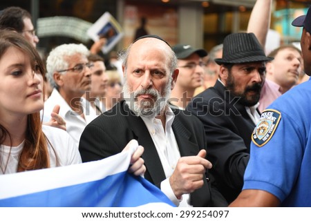 NEW YORK CITY - JULY 22 2015: thousands rallied in Times Square to oppose the President's proposed nuclear deal with Iran. NYPD community affairs personnel keep Neturei Karta members apart from rally