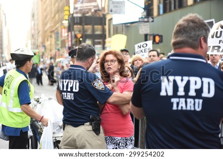NEW YORK CITY - JULY 22 2015: thousands rallied in Times Square to oppose the President\'s proposed nuclear deal with Iran. Woman at rally attempts to confront anti-Zionist Neturei Karta