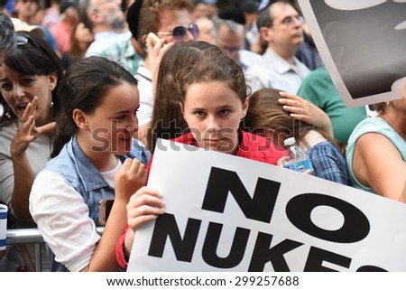NEW YORK CITY - JULY 22 2015: thousands rallied in Times Square to oppose the President\'s proposed nuclear deal with Iran. Rally attendees with NO NUKES sign