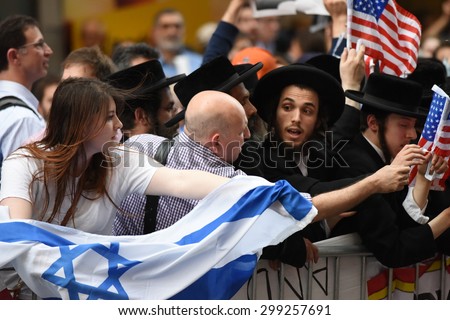 NEW YORK CITY - JULY 22 2015: thousands rallied in Times Square to oppose the President\'s proposed nuclear deal with Iran. Attempts to snatch Palestinian flags away from anti-zionist Neturei Karta
