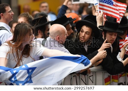 NEW YORK CITY - JULY 22 2015: thousands rallied in Times Square to oppose the President\'s proposed nuclear deal with Iran. Attempts to snatch Palestinian flags away from anti-zionist Neturei Karta