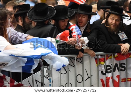 NEW YORK CITY - JULY 22 2015: thousands rallied in Times Square to oppose the President\'s proposed nuclear deal with Iran. Neturei Karta members with US & Palestinian flags
