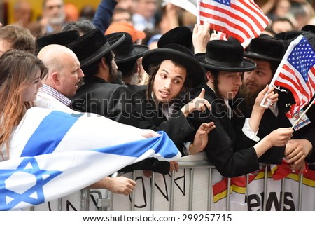 NEW YORK CITY - JULY 22 2015: thousands rallied in Times Square to oppose the President\'s proposed nuclear deal with Iran. Man attempts to grab Palestinian flags away from Neturei Karta members
