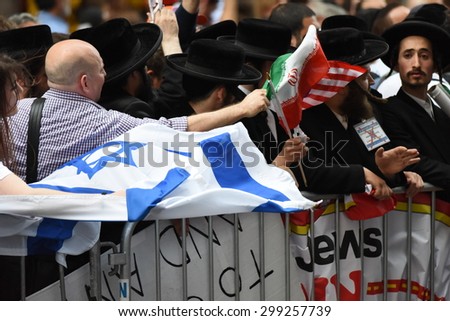 NEW YORK CITY - JULY 22 2015: thousands rallied in Times Square to oppose the President's proposed nuclear deal with Iran. Attempts to snatch Palestinian flags away from Neturei Karta members