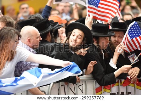 NEW YORK CITY - JULY 22 2015: thousands rallied in Times Square to oppose the President\'s proposed nuclear deal with Iran. Man at rally attempts to snatch Palestinian flag from Neturei Karta members