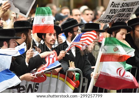 NEW YORK CITY - JULY 22 2015: thousands rallied in Times Square to oppose the President\'s proposed nuclear deal with Iran. Neturei Karta members at rally with Palestinian flags