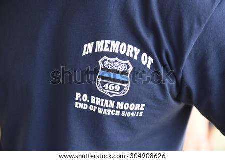 NEW YORK CITY - AUGUST 8 2015: the 25th annual Hong Kong Dragon Boat Festival took place in Flushing Meadows Corona Park, Queens. NYPD crew with memorial shirts