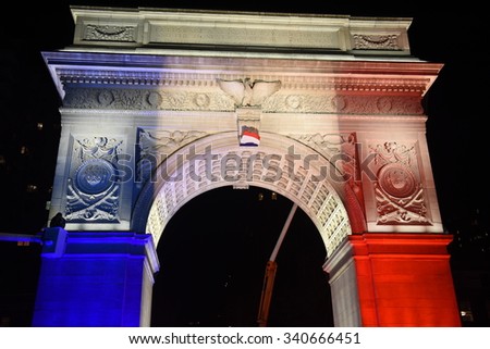 NEW YORK CITY - NOVEMBER 14 2015: A rally at Washington Square Park culminated in a candlelight vigil outside the French consulate for victims of the Paris terror attacks. Wash Square arch lighted