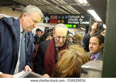 NEW YORK CITY - JANUARY 4 2015: Mayor de Blasio & senator Schumer greeted morning commuters with new benefits available to lower the cost of public transportation.