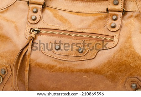 Mustard patent female leather bag isolated on white background.
