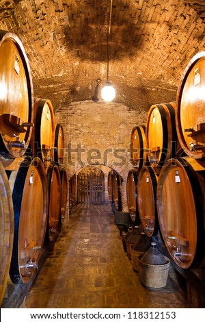 Old traditional wine cellar with big wooden barrels