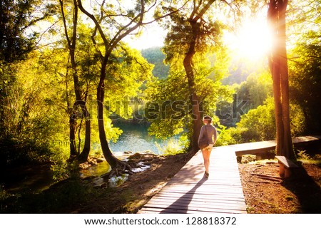 Beautiful young woman walks in Krka national park in Croatia at sunset