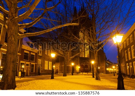 Hooglandsekerkgracht looking at the back of the Hooglandse church in Leiden at twilight in winter with snow in the Netherlands