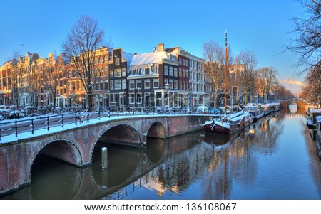 Beautiful early morning winter view on one of the Unesco world heritage city canals of Amsterdam, The Netherlands. HDR