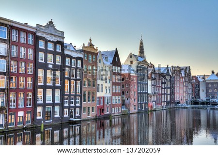 Houses at the waterside of the Damrak in Amsterdam, the Netherlands. HDR
