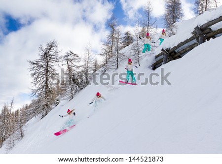 Awesome female snowboarder jumps over an avalanche fence
