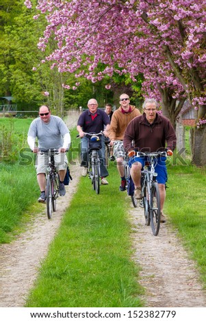RHEINE - MAY 10th, 2013: Group of men cycling in the area of Rheine, Germany, on a spring day on May 10th, 2013. This area is a popular touristic destination to ride bicycles