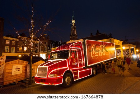 Leiden, The Netherlands - December 16th, 2013: People Walking Past A Beautiful Christmas Coca Cola Truck At The Christmas Market At Night In Leiden, The Netherlands, On December 16th 2013