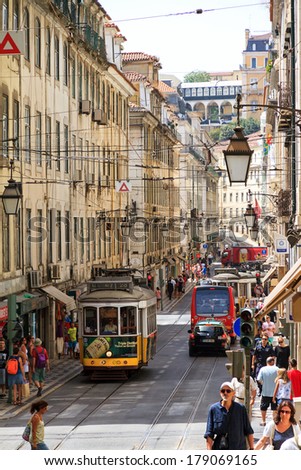 LISBON, PORTUGAL - AUGUST 20, 2013: Typical urban street scene with tourists in Lisbon, Portugal, on August 20, 2013