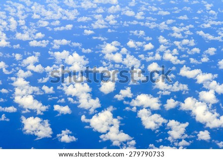 Aerial view on some clouds in the sky above the ocean seen from above