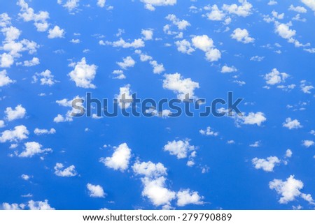 Aerial view on some clouds in the sky above the ocean seen from above
