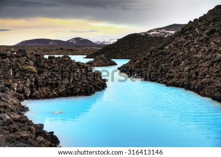 Blue lagoon waters in the lava field landscape of Iceland in winter, HDR