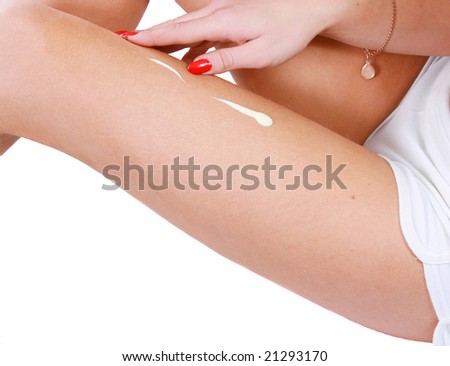 The woman rubs a medical cream on a leg