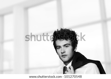 young casual looking businessman with his jacket off and over the shoulder