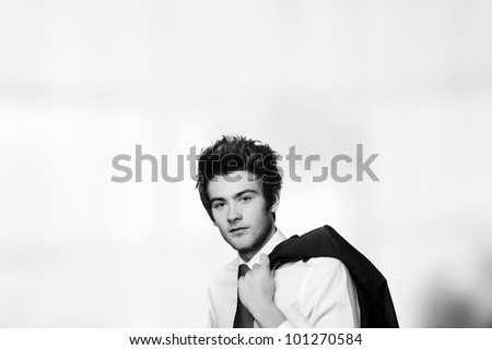 young casual looking businessman with his jacket off and over the shoulder