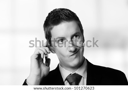 businessman taking a call and he's looks like he not sure about something