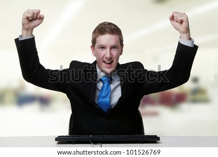 business man with his arm up in the air looking very happy about something