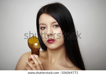 woman holding up a broken bottle what are her plans with this bottle