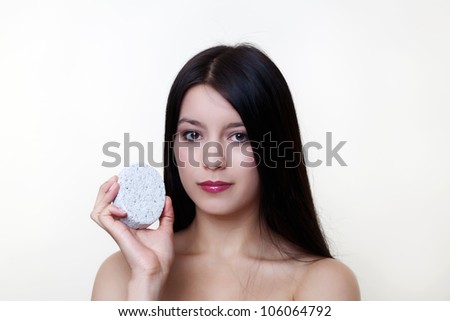 woman exfoliating her skin with a Pumice Stone maybe not the best of ideas
