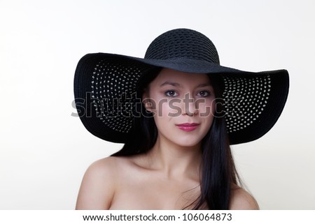 woman with a large floppy hat shot in the studio